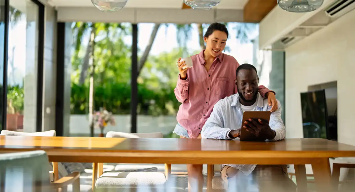 Couple reviewing Barbados property listings online while planning real estate search with buyer’s advisor