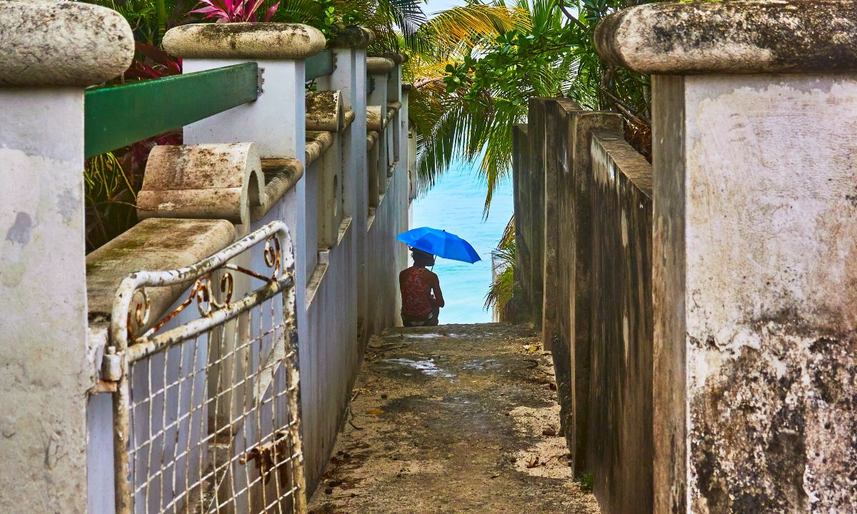 Girl in Barbados street with umbrella