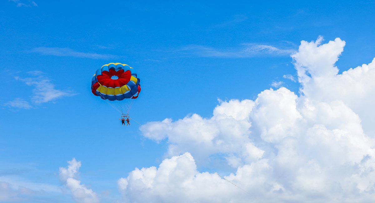 A couple parasailing in barbados on a sunny bright day
