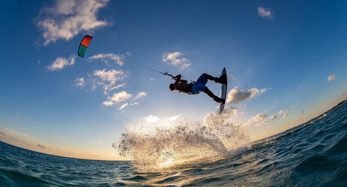 A man kitesurfing over the ocean in barbados