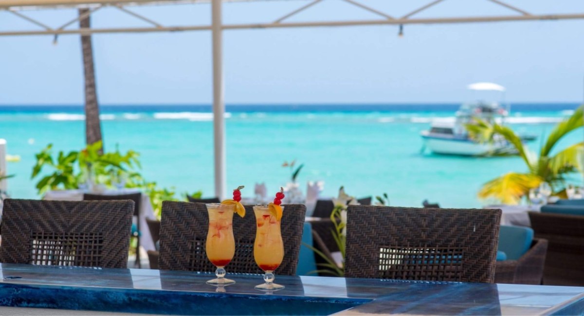 Beachfront terrace at The Sands, Worthing, Christ Church, Barbados, with tropical cocktails and turquoise Caribbean Sea views