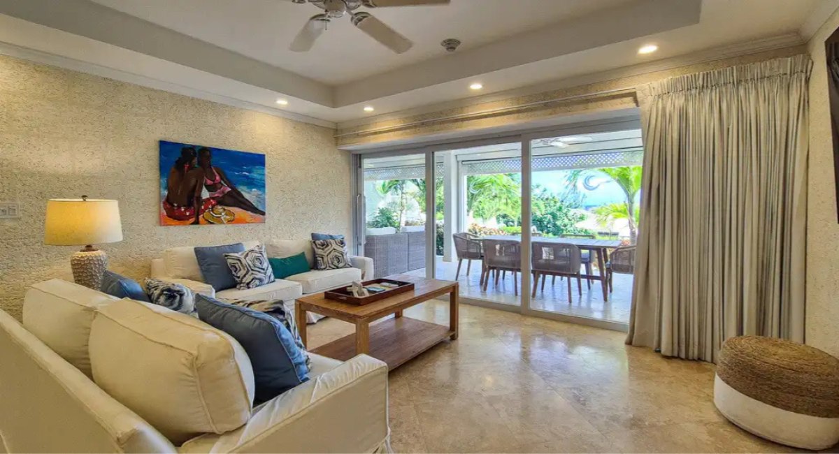 Bright living room with sofas opening onto a private terrace at Crane Private Residence 5213, The Crane Resort, Barbados