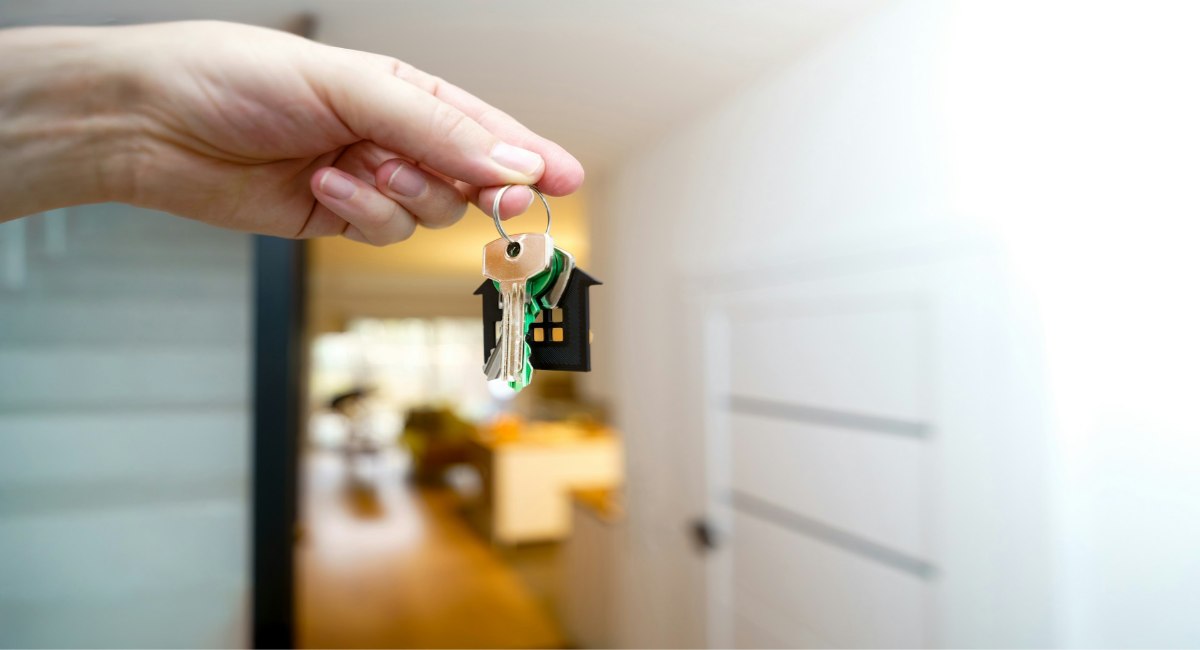 Hand holding house keys, representing property purchase on the West Coast of Barbados